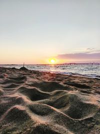 Scenic view of beach against sky during sunset