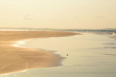 Scenic view of beach against sky during sunset