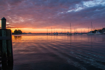 Sailboats in marina at sunset