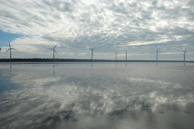 Scenic view of windmills against sky