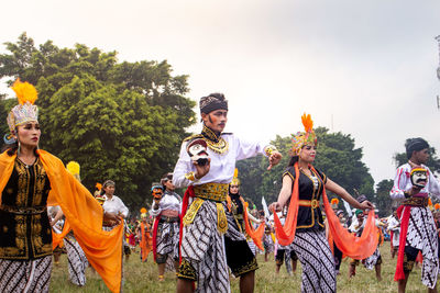 Panoramic shot of people dancing against sky