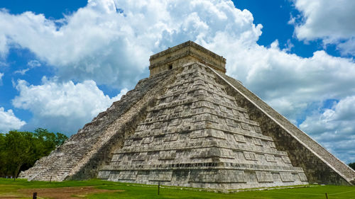 Low angle view of historical building against cloudy sky