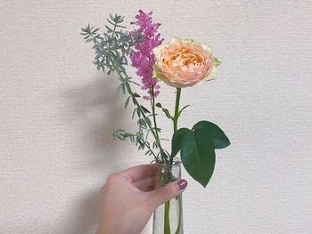 Close-up of hand holding rose bouquet