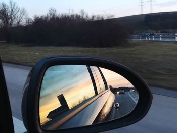 Reflection of sky on side-view mirror