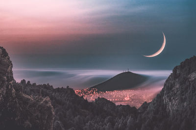 Scenic view of silhouette mountains against sky at sunset