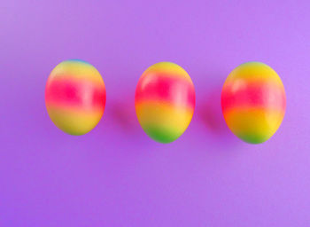 Close-up of multi colored candies against blue background