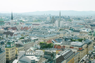 High angle view of buildings in city against clear sky