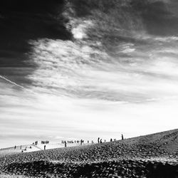 Silhouette of woman against cloudy sky