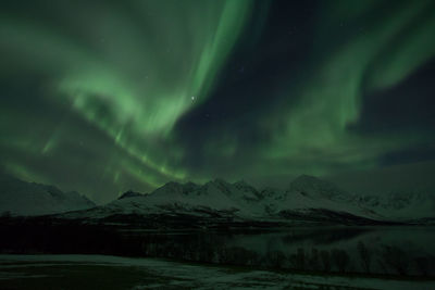 Scenic view of snowcapped mountains against aurora borealis