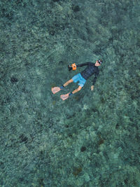 Man with camera swimming in sea