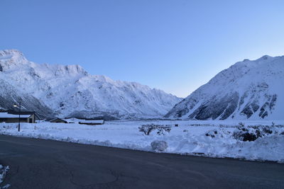 Scenic view of snowcapped mountains against clear blue sky