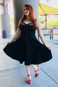 Portrait of beautiful young woman standing outdoors