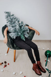 Side view of woman sitting on floor