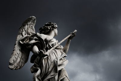Low angle view of statue against sky