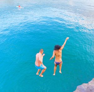 Woman jumping in sea