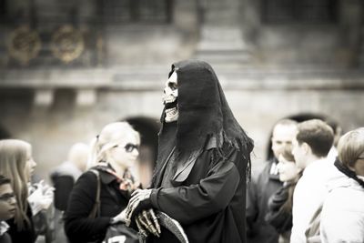 Street performer wearing devil mask