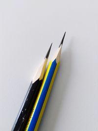 Close-up of colored pencils against white background