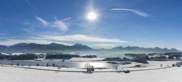Scenic view of snow covered mountains against sky and lake forggensee in bavaria