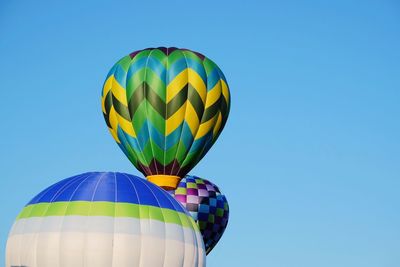 Low angle view of hot air balloon against blue sky