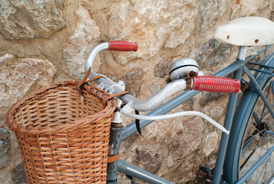 High angle view of bicycle leaning on stone wall