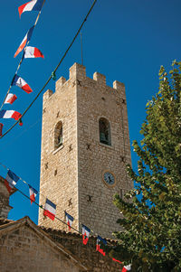 Low angle view of building against clear blue sky