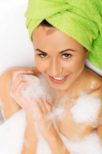 Young woman taking bath in bathroom at home