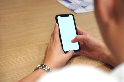 Midsection of woman using mobile phone