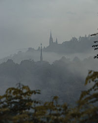 Buildings in city during foggy weather