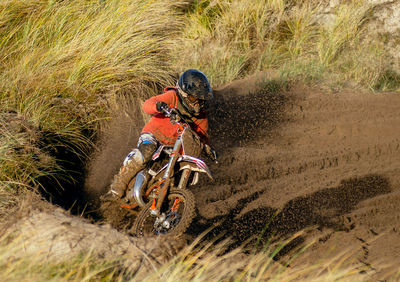 Man riding motorcycle on mud