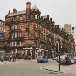 Cars on road against buildings in city