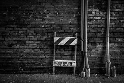 Construction site barrier by brick wall