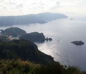 High angle view of sea and mountains against sky