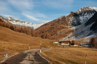 Road leading towards mountains against sky