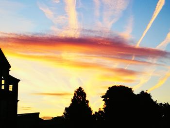 Low angle view of silhouette trees against sky at sunset