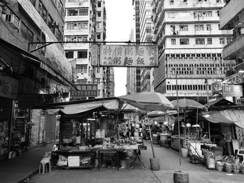 People on street amidst buildings in city