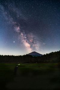 Scenic view of field against sky at night