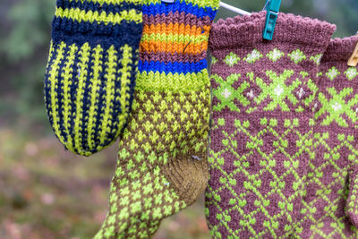 Photography with knitted gloves, gloves hanging on a rope, handicraft concept, knitting as a hobby