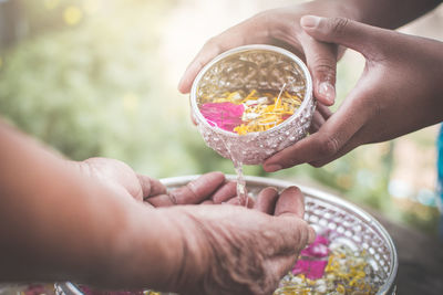 Midsection of girl pouring water on hands