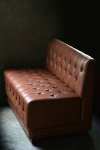 Close-up of sofa on table against black background