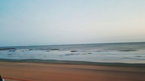 Scenic view of beach against clear sky