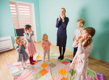 Group of people standing against wall at home