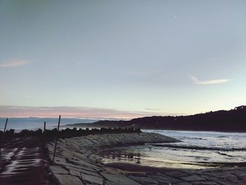 Scenic view of beach against sky during sunset