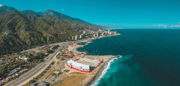 High angle view of city by sea against sky