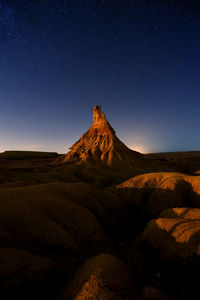 Scenic view of landscape against clear sky at night