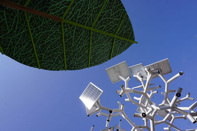 Low angle view of windmill against clear blue sky