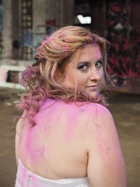 Portrait of a serious young woman with pink hair