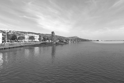 Scenic view of sea by buildings against sky