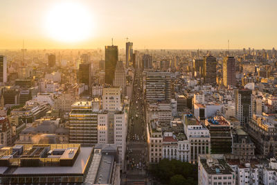 High angle view of buildings in city against sky during sunset