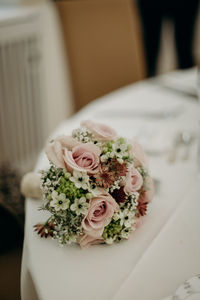 Close-up of rose bouquet on white table