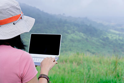 Midsection of woman using mobile phone